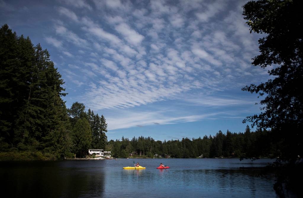 Lily Stewart and Gemma Rommel paddle around Crabapple Lake. (Olivia Vanni / The Herald)