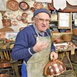 Every day is show-and-tell for this coppersmith in Montepulciano, Italy, as travelers drop by to see him at work. (Rick Steves Europe)