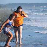 Caraleigh Hernandez (left), 10, and her sister, Denelle, 14, play on the beach at Deception Pass State Park on Whidbey Island. (Emily Gilbert / Whidbey News-Times)