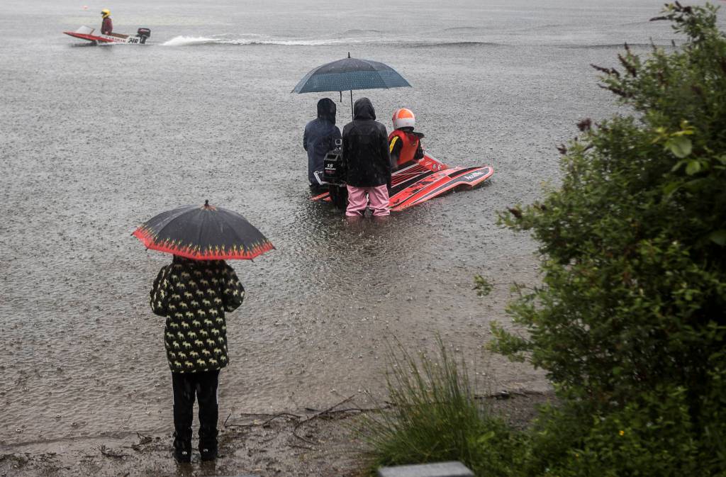 Racers wait in the rain as people make their way into the pits during the on Saturday, June 5, 2021 in Everett, Wash. (Olivia Vanni / The Herald)