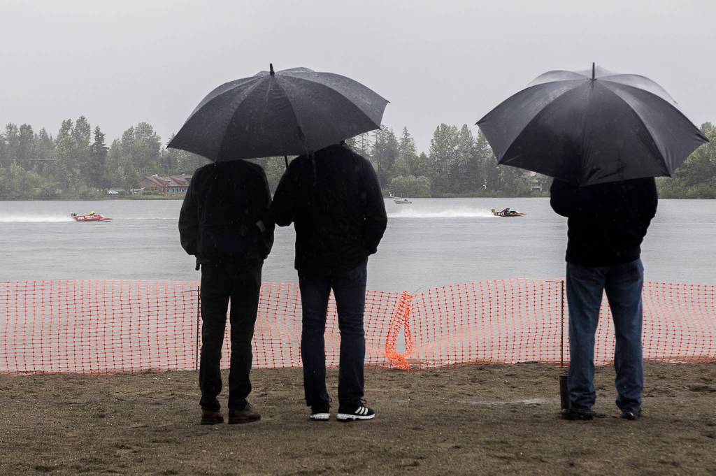 Spectators watch as racers make their way through the starting line on Saturday, June 5, 2021 in Everett, Wash. (Olivia Vanni / The Herald)