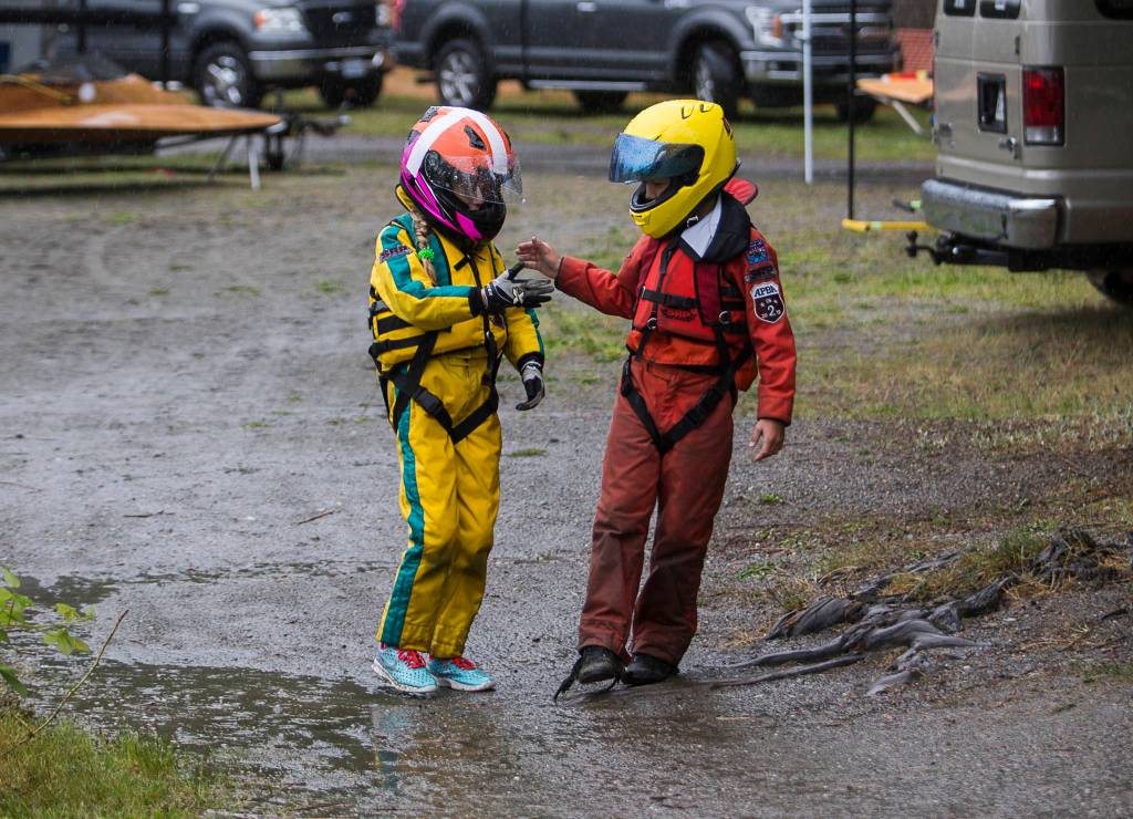 Harper Kelly-Moen and Carson Kelly high five after their races during the Silver Lake Regatta on Saturday, June 5, 2021 in Everett, Wash. (Olivia Vanni / The Herald)