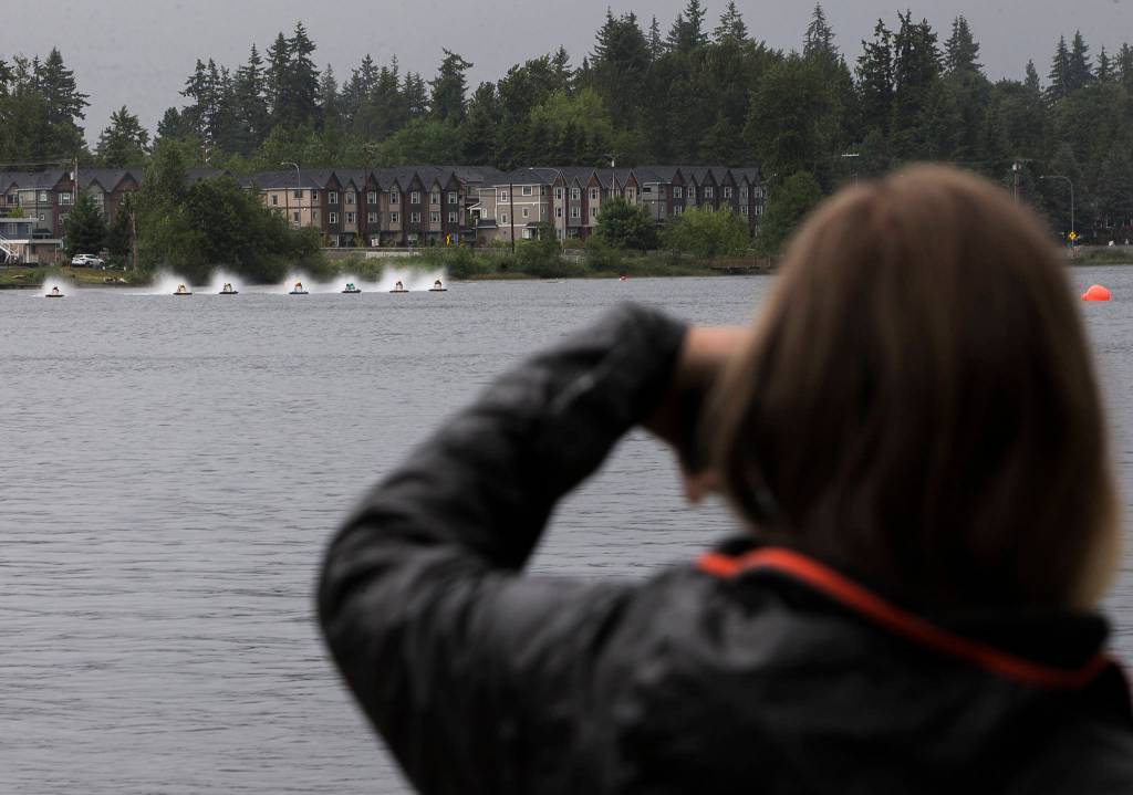 Spectators watch as the hydroplanes race past the start during the Silver Lake Regatta on Saturday, June 5, 2021 in Everett, Wash. (Olivia Vanni / The Herald)