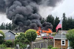 Thick plumes of smoke rose from a house fire Sunday afternoon in the 2000 block of Homestead Avenue in Clinton. (Gregory Doering)