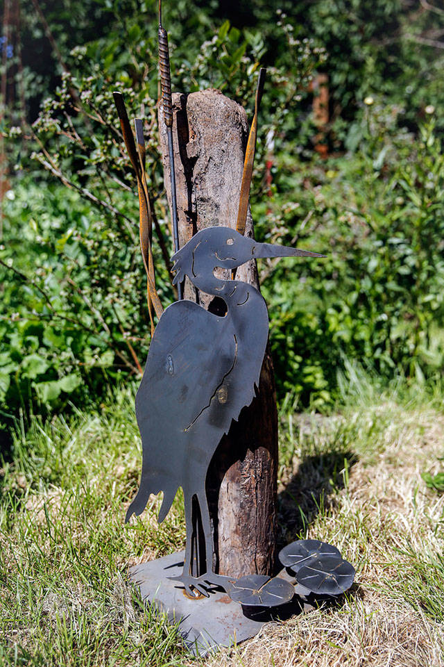 Dennis Cant of Everett works in driftwood, rock and metal to bring his creations to life. (Kevin Clark / The Herald)