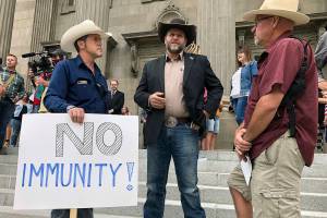 FILE - In this Aug. 24, 2020, file photo, Ammon Bundy, center, who led the Malheur National Wildlife Refuge occupation, stands on the Idaho Statehouse steps in Boise, Idaho. Mainstream and far-right Republicans are battling for control of the party and the state in deeply conservative Idaho. (AP Photo/Keith Ridler, File)