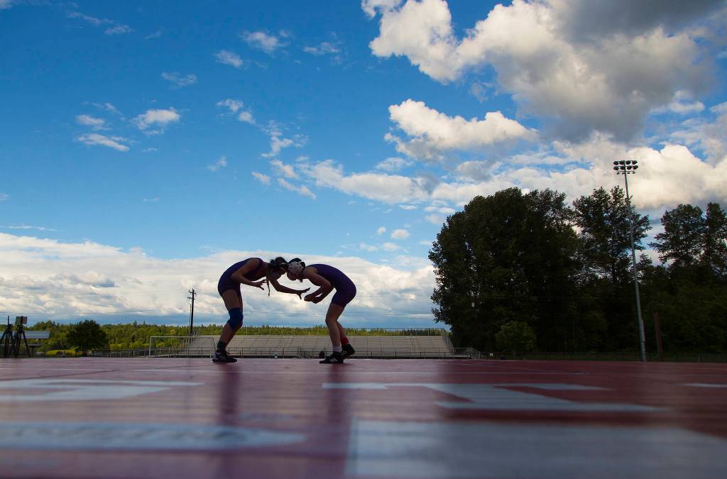 Two wrestlers go head to head during a girls wrestling scramble held outside at Marysville Pilchuck High School on Tuesday in Marysville. (Andy Bronson / The Herald)
