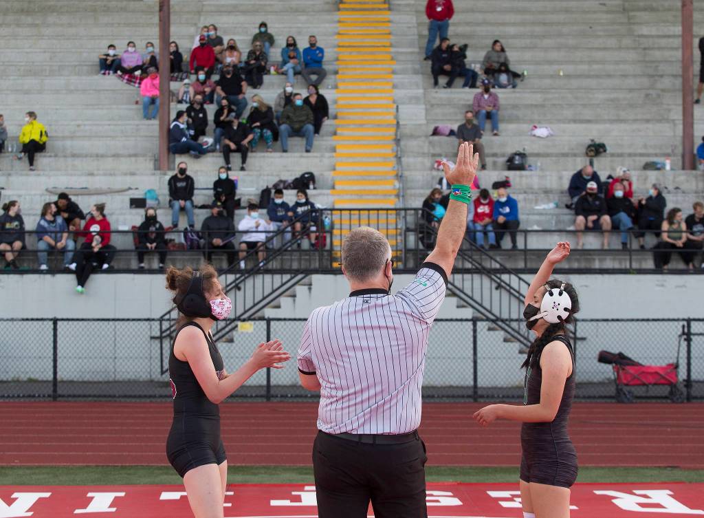 Marysville Pilchucks Emily Heck claps as Jacksons Jocelyn Villa is announced as the winner of their match at a girls wrestling scramble held outside at Marysville Pilchuck High School on Tuesday in Marysville. (Andy Bronson / The Herald)