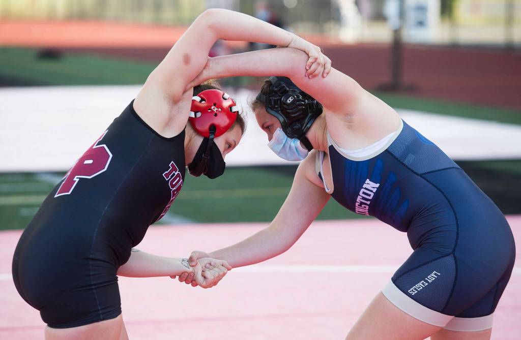 Marysville Pilchucks Chelsea Goeden and Arlingtons Raina Allen battle for control as they compete at a girls wrestling scramble held outside at Marysville Pilchuck High School on Tuesday in Marysville. (Andy Bronson / The Herald)