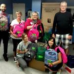 Katie Thurston, left in front row, was among volunteers from First Financial Northwest Bank and the Edmonds Young Professionals packing 135 backpacks with school supplies for the YWCA School Days program in 2018. Front row at right is Yvonne De La Rosa. Back row, from left: Yusuf Hansia, Jane Tocco, Kristie Gilchrist and Gary Walderman. (Herald file photo)