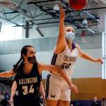 Lake Stevens Bella Evans (right) reaches for a loose ball with Arlingtons Jenna Villa defending during a game on Wednesday evening at Lake Stevens High School. Arlington won 80-71. (Kevin Clark / The Herald)