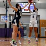 Arlingtons Jenna Villa (left) blocks a shot attempt by Lake Stevens Baylor Thomas during a game on Wednesday evening at Lake Stevens High School. Arlington won 80-71. (Kevin Clark / The Herald)