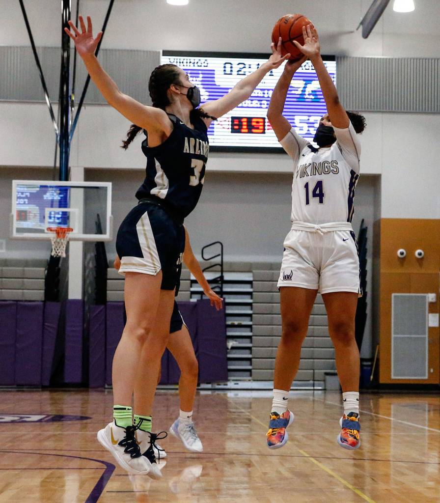 Arlingtons Jenna Villa (left) blocks a shot attempt by Lake Stevens Baylor Thomas during a game on Wednesday evening at Lake Stevens High School. Arlington won 80-71. (Kevin Clark / The Herald)