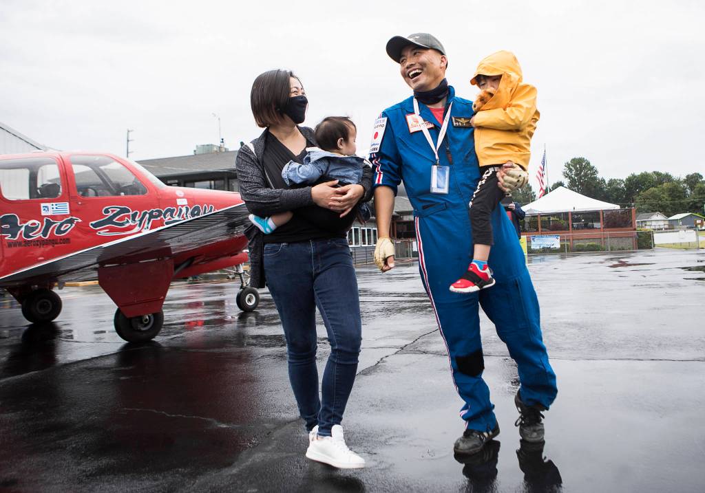 Shinji Maeda and his wife, Makiko Maeda, holding their children, Tsubasa, 3, and Sana, 9 months, after Shinji landed on Friday in Snohomish. (Olivia Vanni / The Herald)