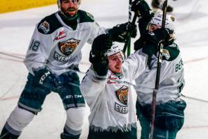 Silvertips' Ethan Regnier (bottom) celebrates a goal against the Spokane Chiefs during the final home game Friday night at Angel of the Winds Arena in Everett on May 7, 2021.  (Kevin Clark / The Herald)