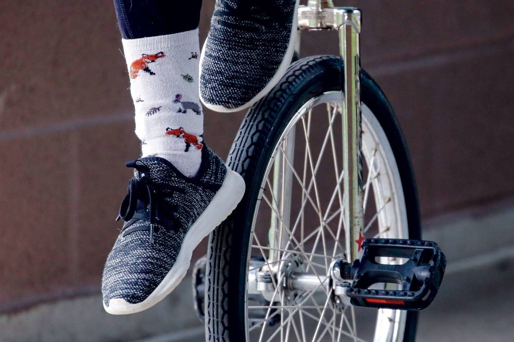 Patsy May does a wheel walk on her unicycle. (Kevin Clark / The Herald)
