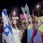 Israelis celebrate the swearing in of the new government in Jerusalem on Sunday. Israels parliament has voted in favor of a new coalition government, formally ending Prime Minister Benjamin Netanyahus historic 12-year rule. (AP Photo/Sebastian Scheiner)