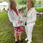 Hay Look Me Over, a Biewer terrier, with her handler, Molly Speckhardt, left, and owner Lynn McKee, of Lake Stevens. The 2-year-old terrier won a Westminster Kennel Club Dog Show ribbon for second among the girls in her class. (Submitted photo)