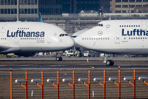 FILE - In this Feb.14, 2019 file photo, an Airbus A380, left, and a Boeing 747, both from Lufthansa airline pass each other at the airport in Frankfurt, Germany. The United States and the European Union on Tuesday appeared close to clinching a deal to end a damaging dispute over subsidies to Airbus and Boeing and lift billions of dollars in punitive tariffs. (AP Photo/Michael Probst, File)
