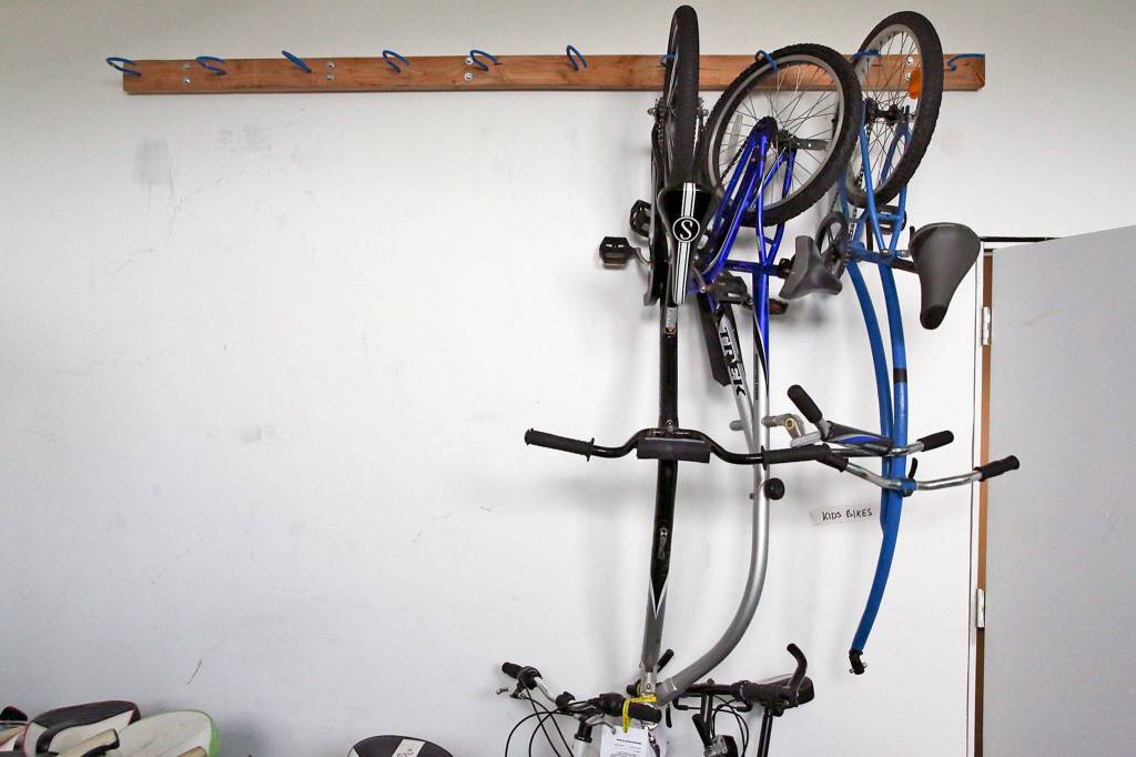 Tag-along bikes are stored in preparation for a garage sale at Sharing Wheels in Everett. (Kevin Clark / The Herald)