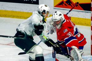 Silvertips' Cole Fonstad attempts a shot with Chiefs' Mason Beaupit defending during the final home game Friday night at Angel of the Winds Arena in Everett on May 7, 2021.  (Kevin Clark / The Herald)