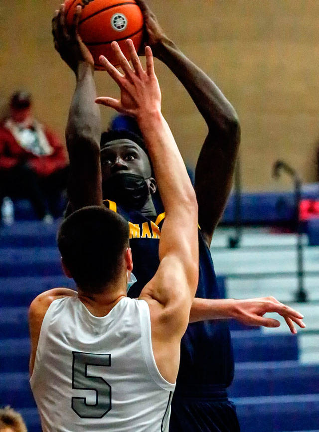 Mariners BJ Kolly attempts a shot over Glacier Peaks Tucker Molina in the third quarter of a game at Glacier Peak High School in Snohomish on May 27. (Kevin Clark / The Herald)