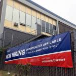 The Everett Post Office is shown with a now hiring sign in 2019. The state added 8,300 jobs last month. (Sue MIsao / Herald file)