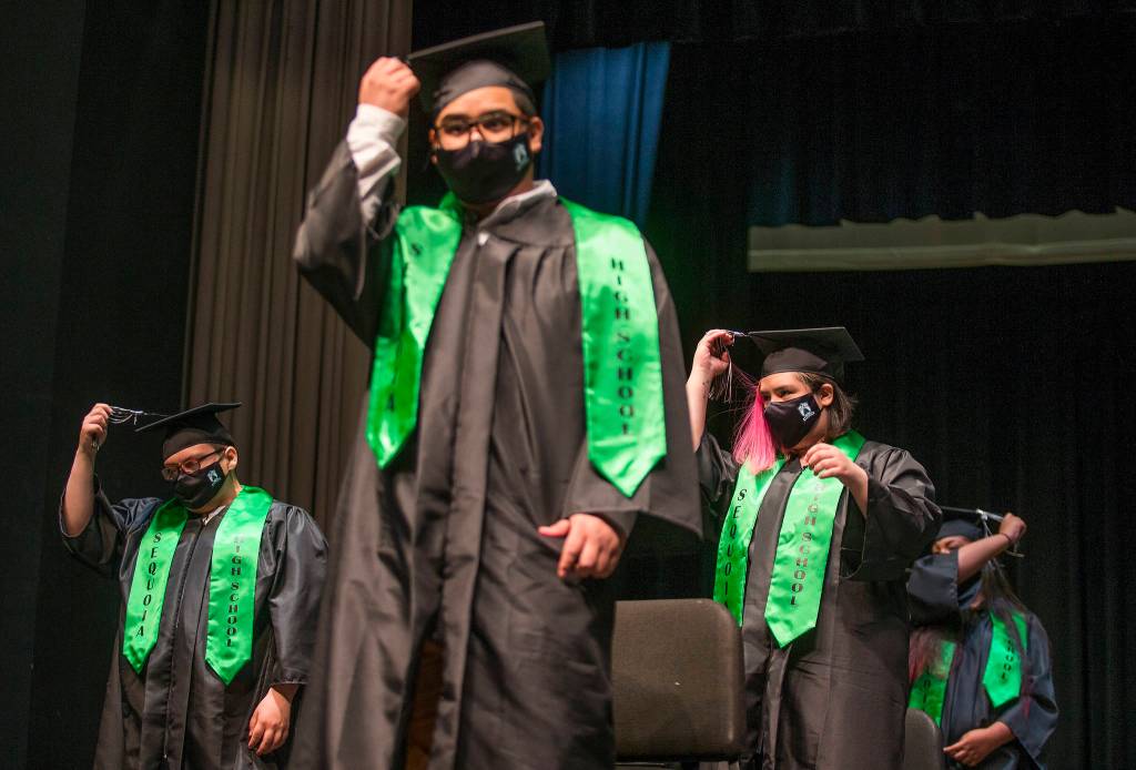 Sequoia High graduates move their tassels from one side to the other at the end of the graduation ceremony Thursday in Everett. (Andy Bronson / The Herald)