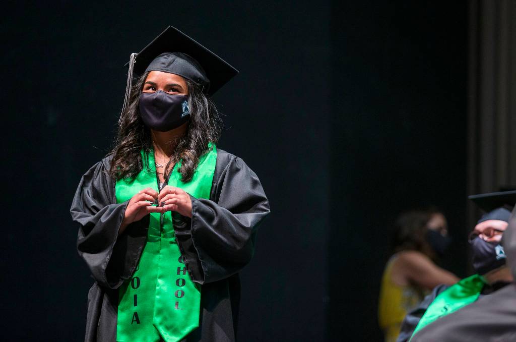 Alanny Mack makes a heart shape with her hands as people cheer for her during Sequoia Highs graduation ceremony Thursday in Everett. (Andy Bronson / The Herald)