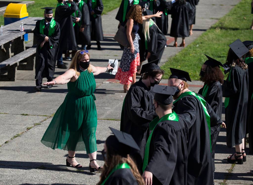 Sequoia High principal Kelly Shepard instructs students to spread out while lining up before the graduation ceremony Thursday in Everett. (Andy Bronson / The Herald)