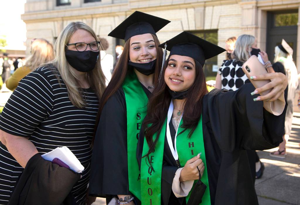 Teacher Rochelle Schultz (left) takes a selfie with Layla Ozturk and Angelica Zamora before Sequoia High holds its graduation ceremony Thursday in Everett. (Andy Bronson / The Herald)