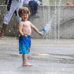 Wyatt Podoll, 2, plays in the Rotary Centennial Water Playground at Forest Park in Everett on Saturday. The splash pad reopened over the Memorial Day weekend as COVID restrictions were eased. (Olivia Vanni / The Herald)