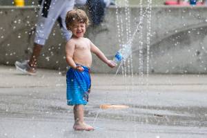 Wyatt Podoll, 2, plays in the Rotary Centennial Water Playground at Forest Park that reopened over Memorial Day weekend due to the easing of COVID restrictions in Phase 3 on Saturday, June 19, 2021 in Everett, Wa. (Olivia Vanni / The Herald)