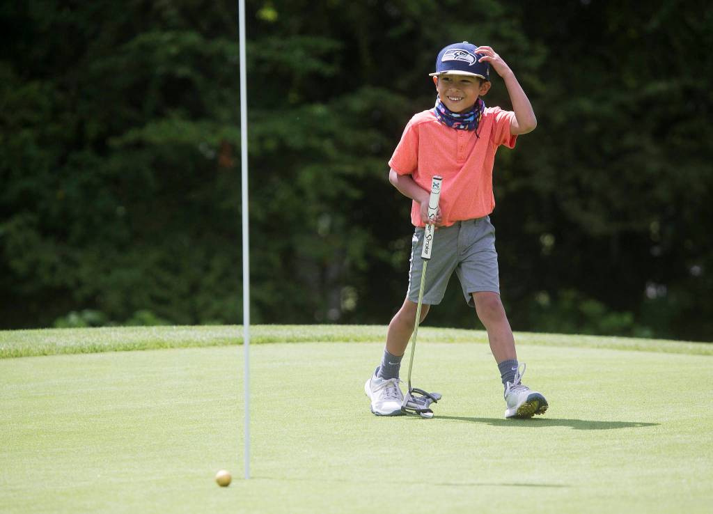 Max Soterakopoulos, 6, reacts as his putt comes up short of the hole Tuesday while golfing at Legion Memorial Golf Course in Everett. Max hit a hole-in-one on the 14th hole at the golf course May 29. (Andy Bronson / The Herald)
