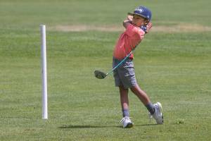 Barely taller than the 150yard marker,  Max Soterakopoulos, 6, tees off as he and his family golfs at Legion Memorial Golf Course on Tuesday, June 15, 2021 in Everett, Washington. Soterakopoulos hit a hole-in-one on the 14th hole at the golf course.  (Andy Bronson / The Herald)