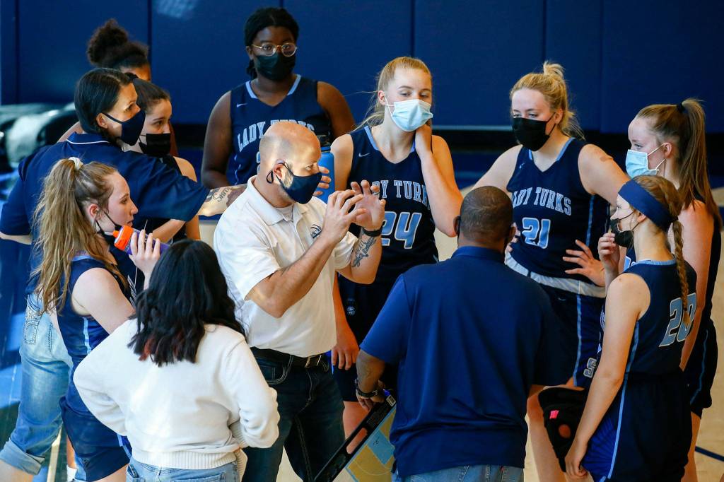 Third-year Sultan coach Todd Weideman (center) has guided the Turks to their highest win total in more than a decade. (Kevin Clark / The Herald)