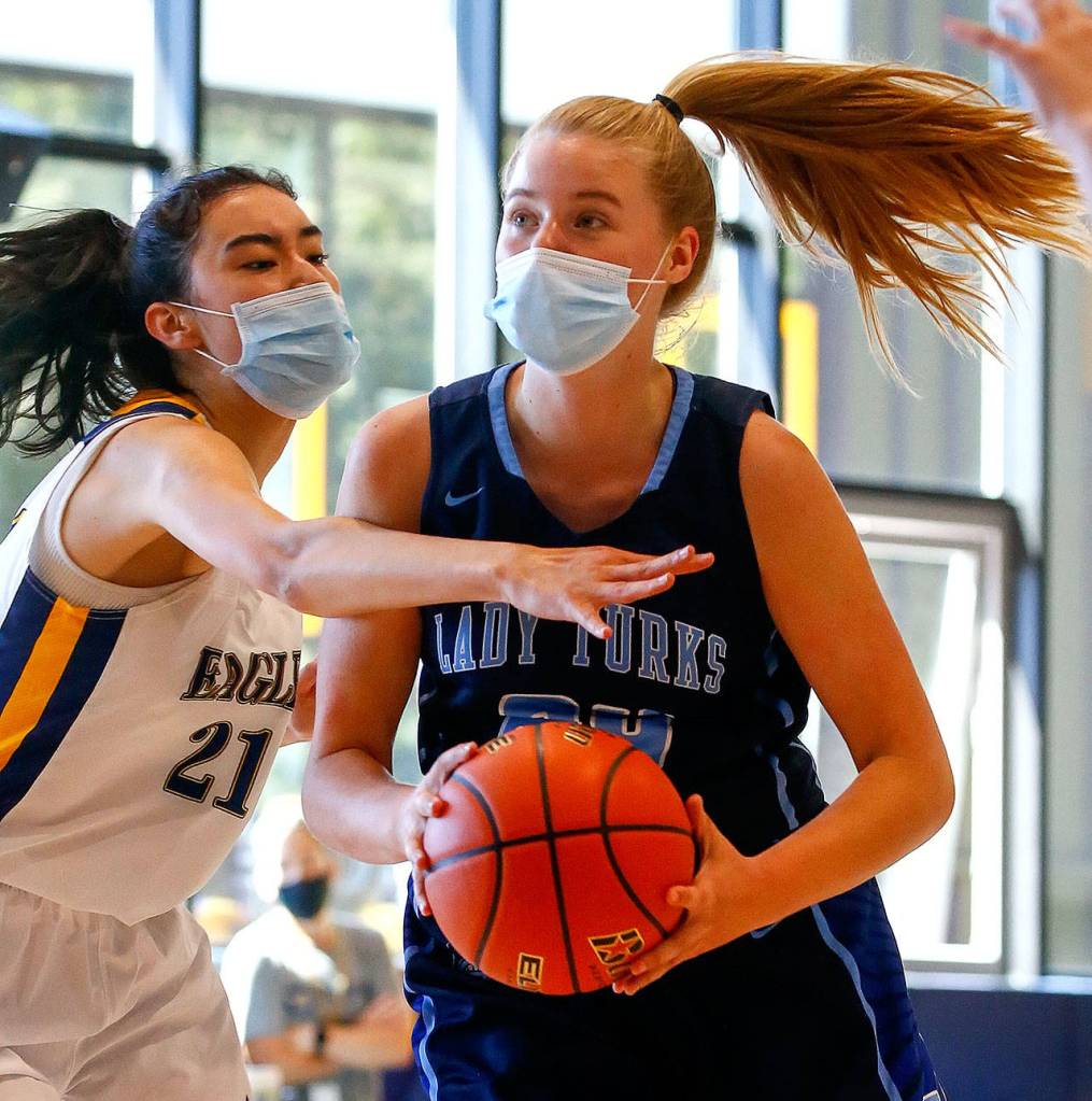 Sultans Faith Anderson (right) drives to the basket. (Kevin Clark / The Herald)