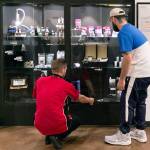 Carmen Miller, (left) helps Ezekiel Eagle with his selection at Tulalip Remedy in Tulalip on August 22, 2018.  (Kevin Clark / The Herald)