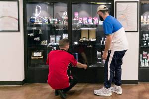 Carmen Miller, (left) helps Ezekiel Eagle with his selection at Tulalip Remedy in Tulalip on August 22, 2018.  (Kevin Clark / The Herald)