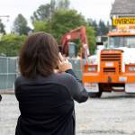 Lake Stevens residents Robert Loss (left) and Carol Ward watch as the Grimm House is towed to its new home. (Isabella Breda / The Herald)