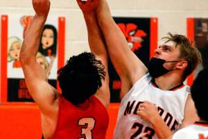 Monroe's Sam Olson blocks Snohomish's Josh Vandergriend shot Tuesday night at Monroe High School on May 11, 2021. The Tigers won 36-35. (Kevin Clark / The Herald)
