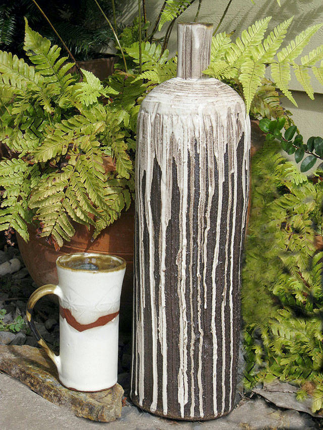 A ceramic mug and bottle in old white glaze by Sally Chang.