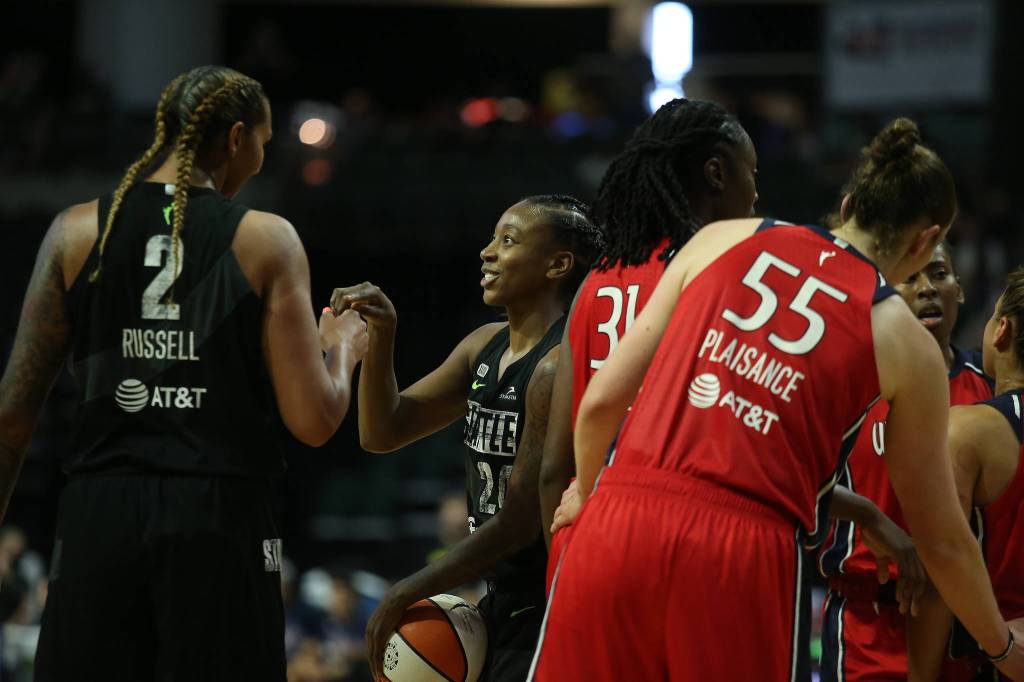 The Storms Jewell Loyd is congratulated by Mercedes Russell after passing the 3,000 career points mark during a game against the Mystics on Tuesday evening at Angel of the Winds Arena in Everett. (Andy Bronson / The Herald)