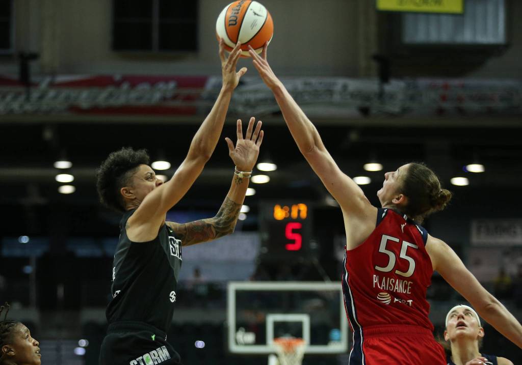 The Storms Candice Dupree has her shpt tipped by the Mystics Theresa Plaisance during a game on Tuesday evening at Angel of the Winds Arena in Everett. (Andy Bronson / The Herald)