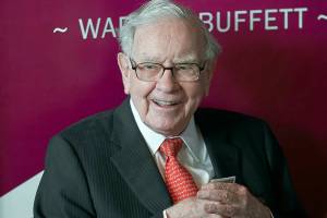 FILE - In this May 5, 2019, file photo Warren Buffett, Chairman and CEO of Berkshire Hathaway, smiles as he plays bridge following the annual Berkshire Hathaway shareholders meeting in Omaha, Neb. Warren Buffett made a $4.1 billion annual philanthropic contribution and said he’s halfway through his goal of giving away most of his money. The billionaire investor also said he is stepping down as trustee of the Bill and Melinda Gates Foundation as he exits all other corporate boards. (AP Photo/Nati Harnik, File)