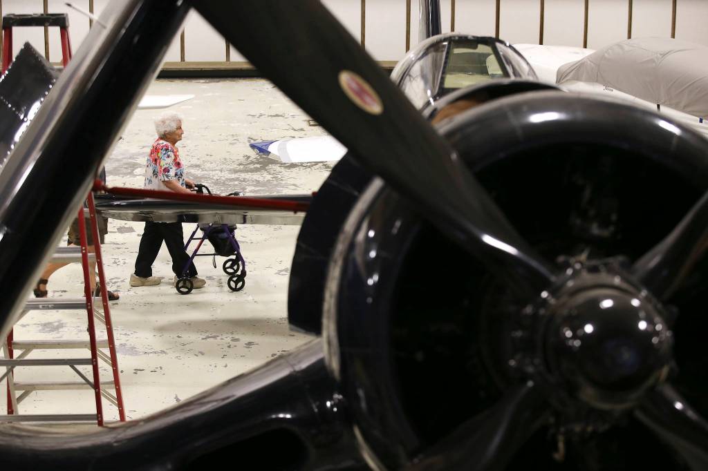 Helen Mary Vaudrin, a Rosie the Riveter at the Goodyear Aircraft plant in Akron, Ohio, during World War II, walks behind a Goodyear F2G-1 Super Corsair during a visit to the Museum of Flights Restoration Center & Reserve Collection at Paine Field on Wednesday in Everett. (Andy Bronson / The Herald)