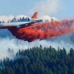 An aerial tanker drops fire retardant on a wildfire burning near Twisp, in August, 2015. Three firefighters were killed battling the blaze. (Ted S. Warren / Associated Press file photo)