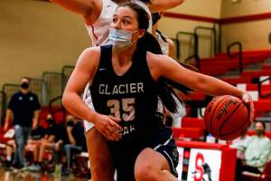 Glacier Peak's Maya Erling drives with Snohomish's Kyra Beckman defending Friday evening at Snohomish High in Snohomish on May 28, 2021. The Grizzles won 59-35. (Kevin Clark / The Herald)