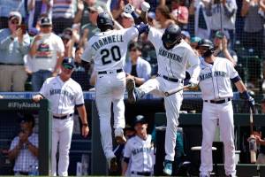 Seattle Mariners' Taylor Trammell is greeted at home by J.P. Crawford after hitting a solo home run on a pitch from Colorado Rockies starting pitcher German Marquez during the sixth inning a baseball game, Wednesday, June 23, 2021, in Seattle. (AP Photo/John Froschauer)