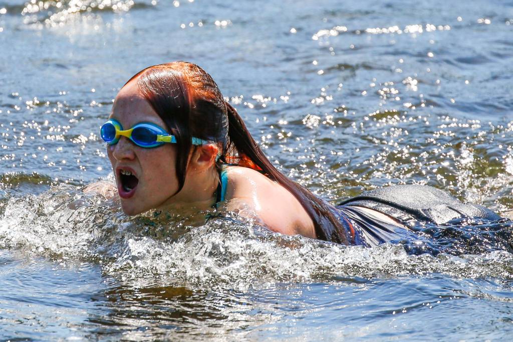 Cooling off in the Pilchuck River in Snohomish on Monday. (Kevin Clark / The Herald)